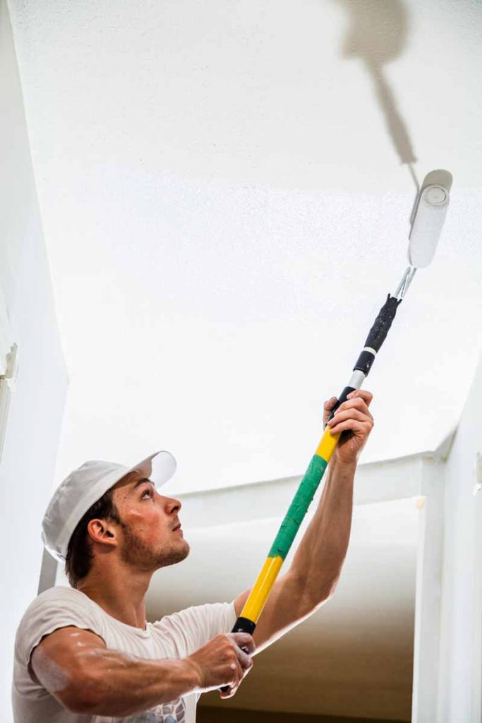 Closeup of Man Painting the Ceiling